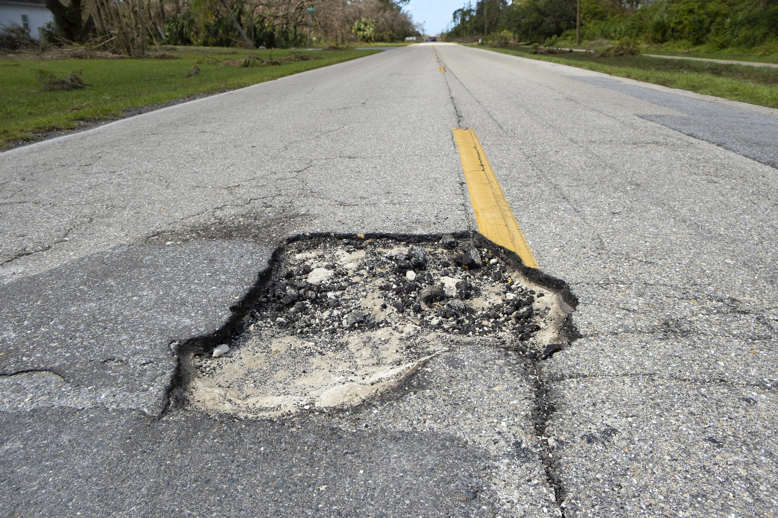 Damaged Asphalt Road With Deep Pothole On American Highway Surfa
